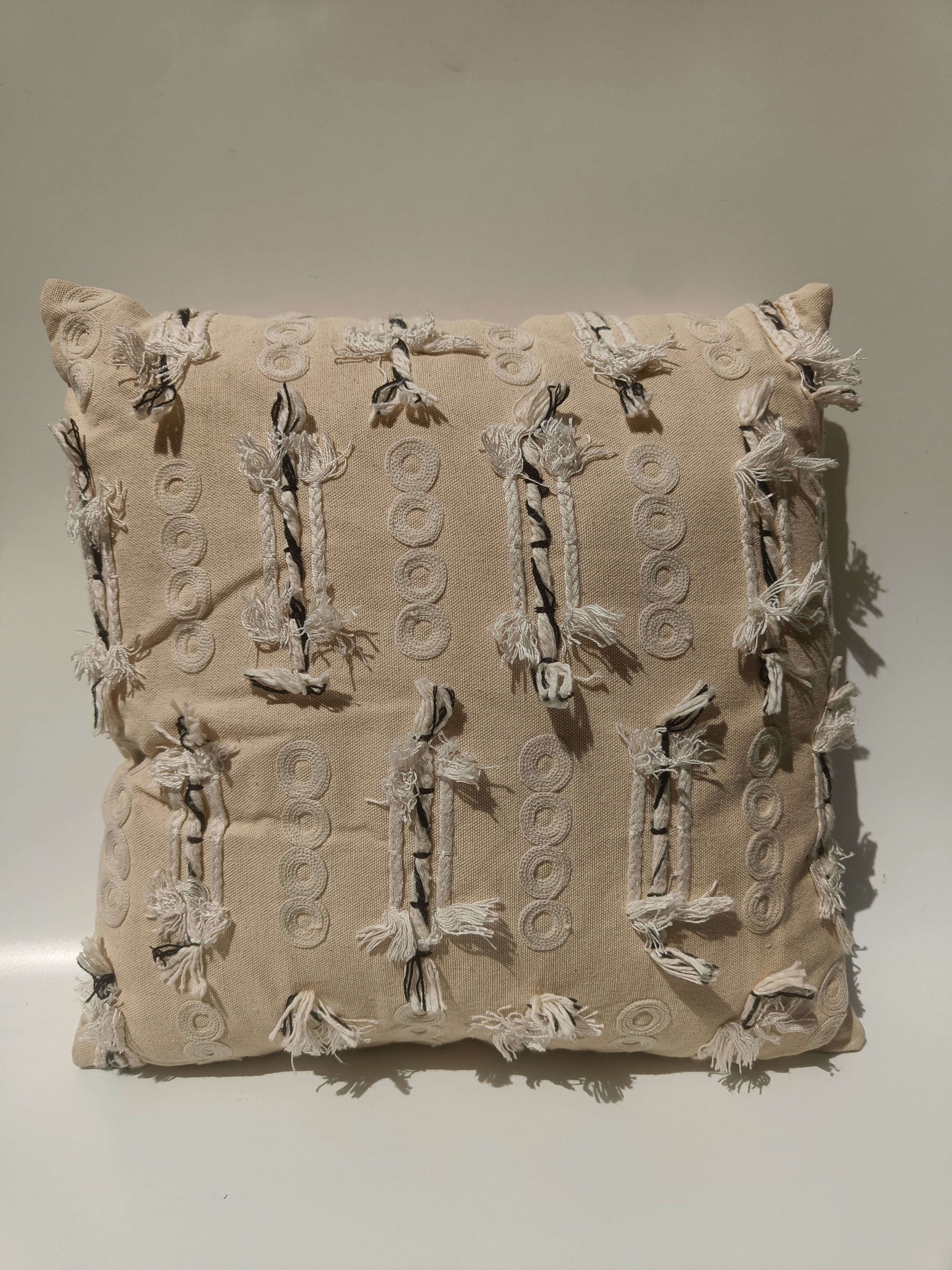 Textured Beige Boho Cushion with Tassel Accents