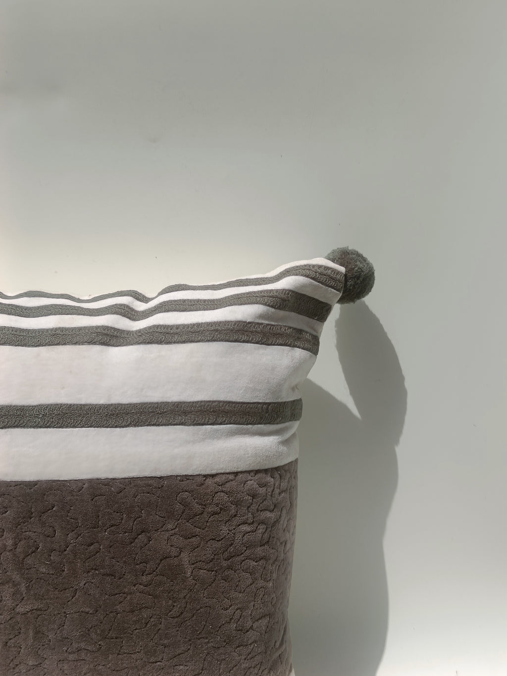 Elegant Velvet Striped Cushion with Pom-Pom Corners