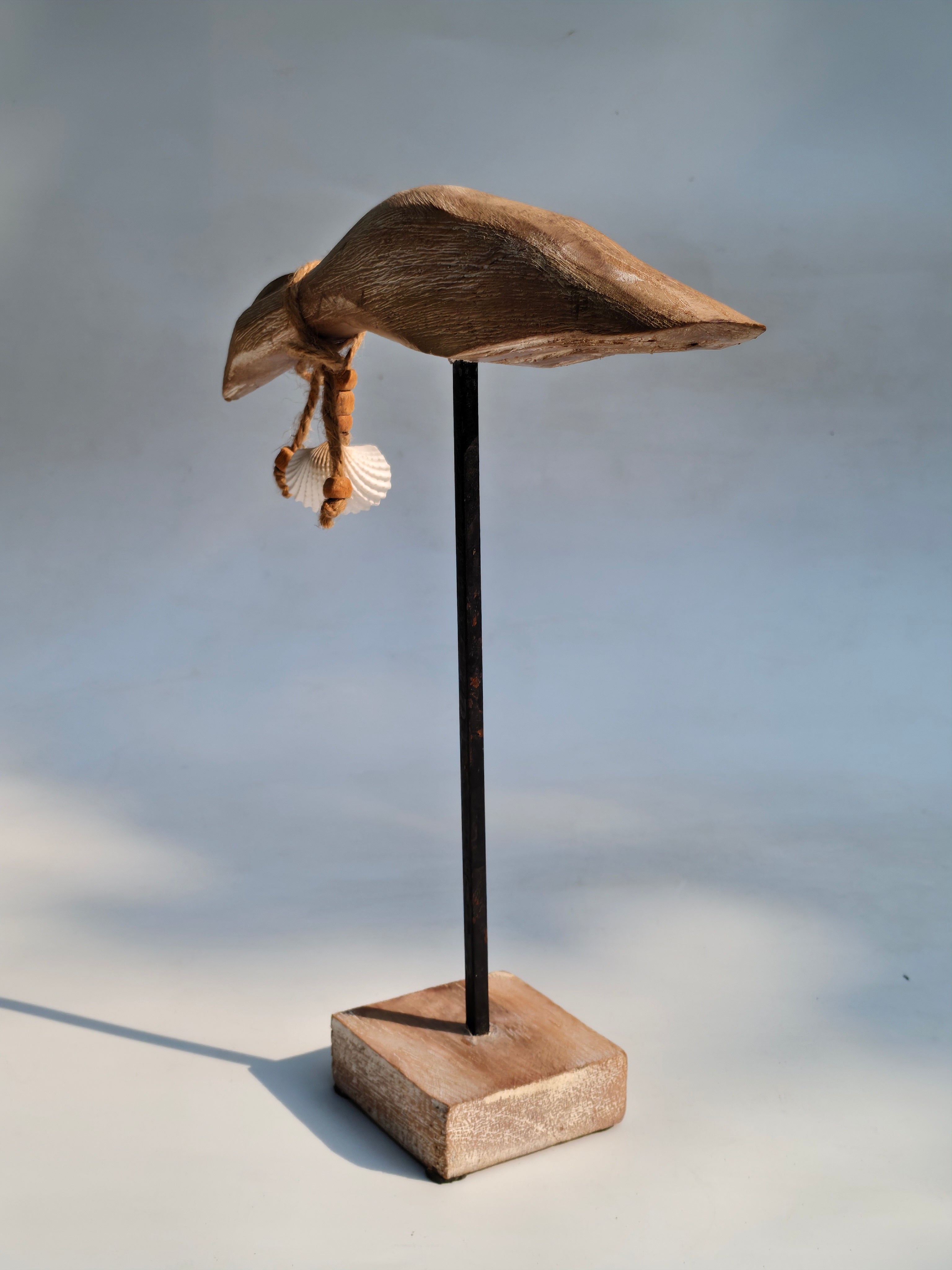 Handcrafted Wooden Bird Sculpture with Shell Accent